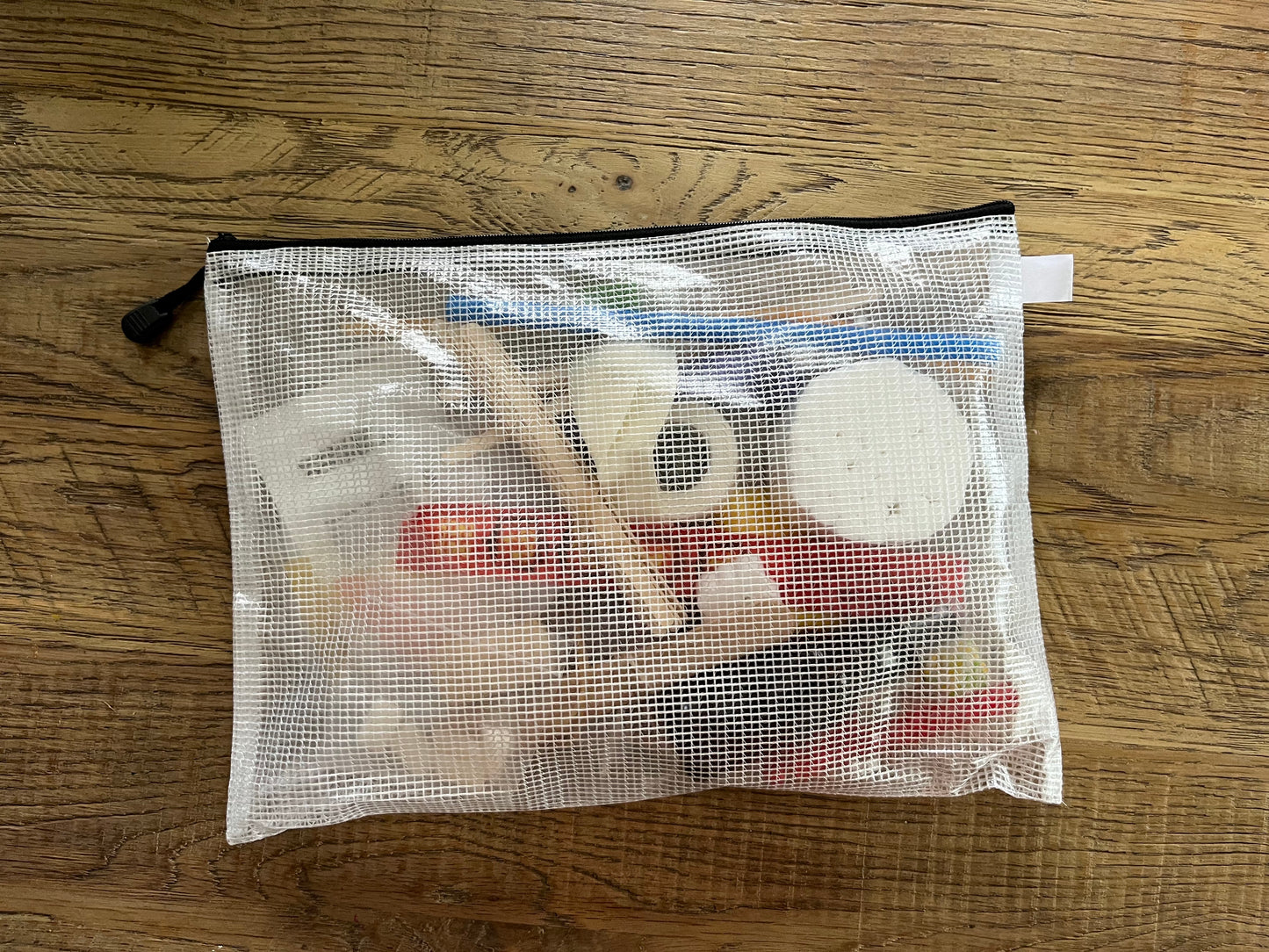 Semi-transparent Zippered bag with contents of at-home therapy kit