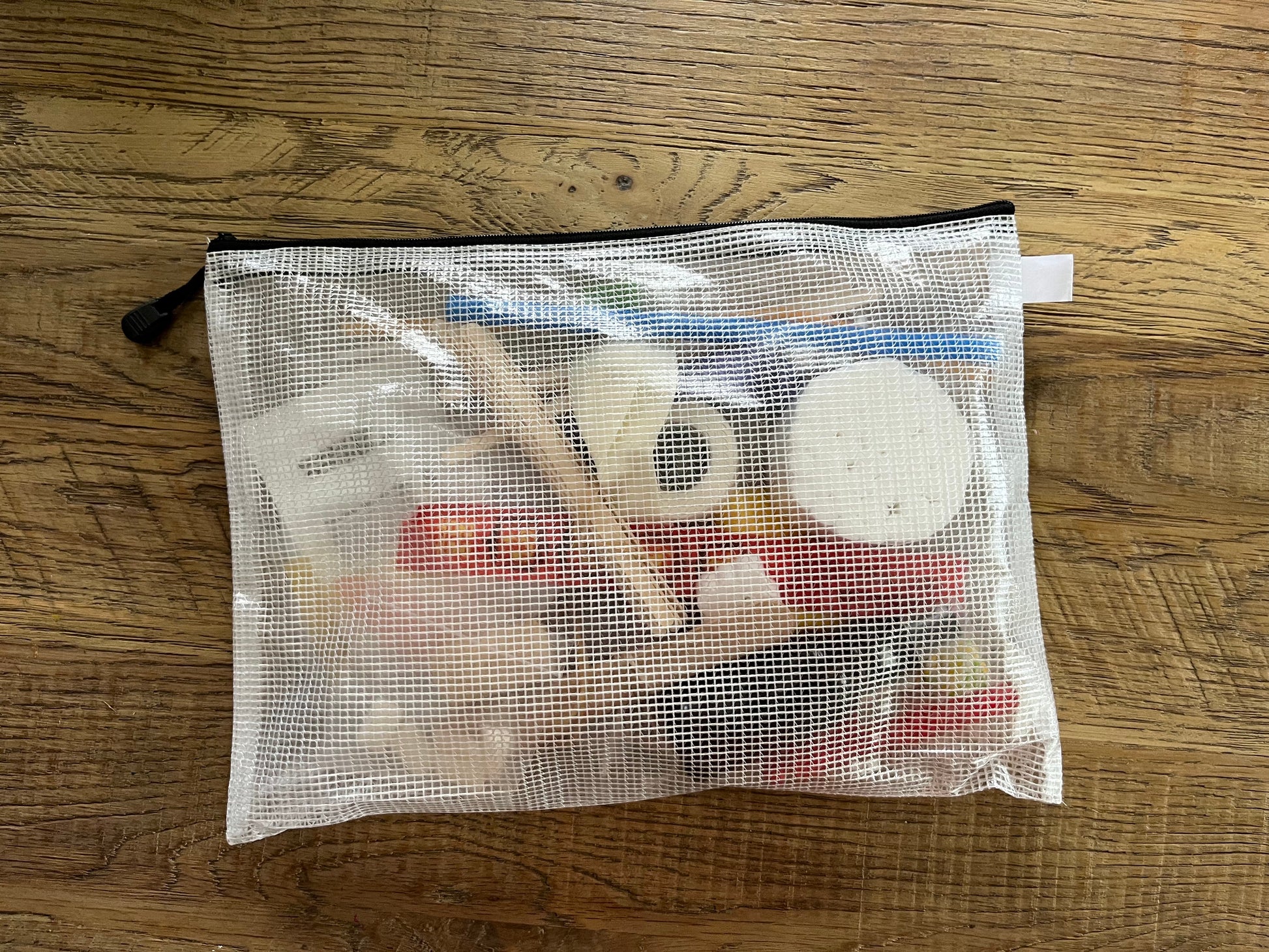 Semi-transparent Zippered bag with contents of at-home therapy kit