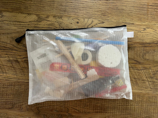 Semi-transparent Zippered bag with contents of at-home therapy kit